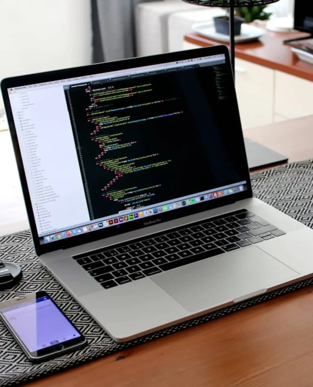 Laptop on a desk displaying code